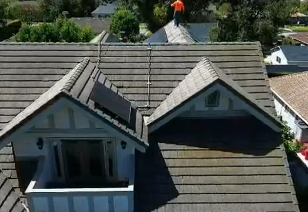 1800 Construction crew on a tile roof project